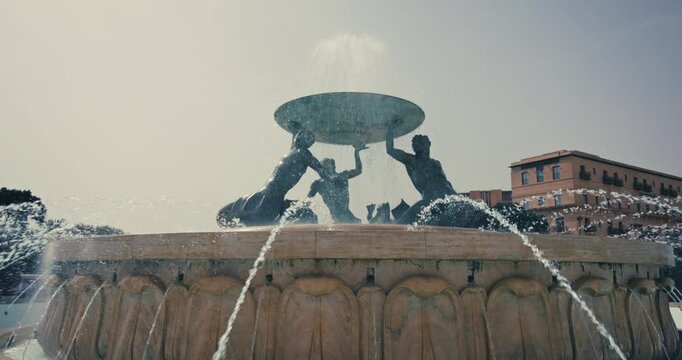 A fountain in the cityscape of the tourist city of Valletta, Malta. Beautiful city streets of a European city. High quality 4k footage