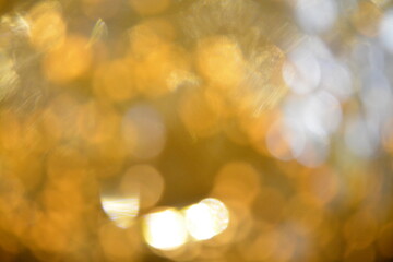 abstract of glowing blurred lights forming golden circles of various intensity. 