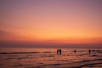 a purple and orange sky with a sunset in the background