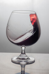 Red wine splashes in the glass 
