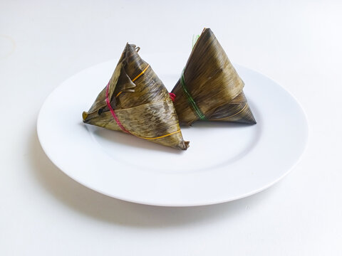Bacang or bakcang, a type of savory chinese dumpling from sticky rice or glutinous rice, filled with minced pork or chicken, wrapped in bamboo leaves, then steamed.