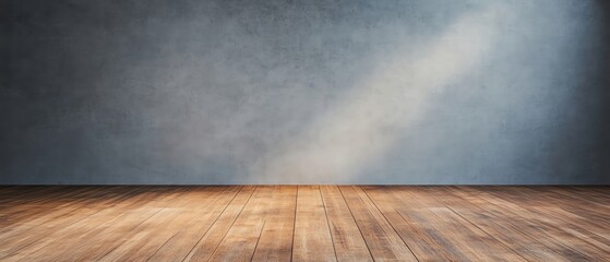 Empty room with wooden floor and soft light illuminating the wall.