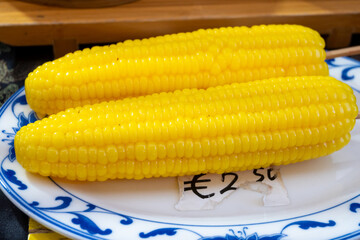 Steamed sweet corn in asian food court on weekly market, vegetarian asian food