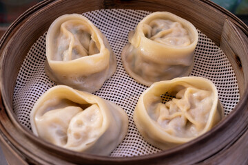 Asian food, steamed cooked filled gyoza dumplings in street cafe ready to eat