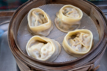 Asian food, steamed cooked filled gyoza dumplings in street cafe ready to eat