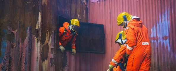 They are wearing orange jumpsuits and yellow helmets