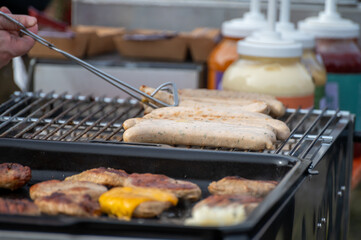 German streetfood, many BBQ wood-fired or charcoal-grilled sausages wurst ready to eat in outdoor cafe, picnic