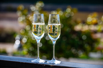 Tasting sparkling white wine, traditional champagne method making of cremant in caves on Moselle river valley in Luxembourg, glass of wine
