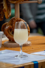 Autumn wine festival in Schengen, Luxembourg on Moselle river valley, tasting of federweisser young wine, neuer wein fermented freshly pessed auxerrois grape juice, or must.