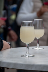 Autumn wine festival in Schengen, Luxembourg on Moselle river valley, tasting of federweisser young wine, neuer wein fermented freshly pessed auxerrois grape juice, or must.