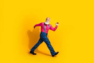 Fototapeta na wymiar Full size photo of old gentleman walk hurry black friday dressed glamour stylish outfit party isolated vibrant yellow color background