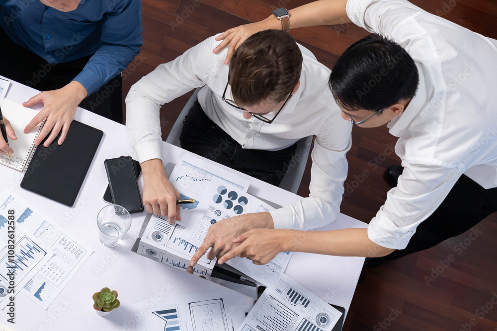 Poster Top view analyst team utilizing BI Fintech to analyze financial data at table in meeting room. Analytic BI dashboard power on paper for business insight and strategic marketing planning. Prudent