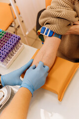 Medical professional performing blood draw procedure with precision in a clinical setting