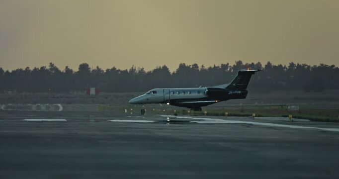 Business Jet Taxiing on Airport Runway at Sunset Symbolizing VIP Private Air Travel and Luxury Business Aviation. High quality 4k footage