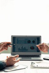Team of data analysts with laptops and financial graph documents in hand With online reviews Meet the market research Statistics with collaboration, close-up, vertical