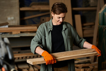 A female carpenter focuses intently on shaping a piece of wood, showcasing her craftsmanship and skill.