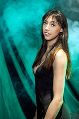 Naklejka premium Portrait of Woman in Black Dress Against Smoky Green Backdrop
