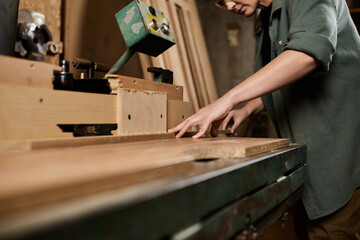 Craftswoman meticulously working with wood in a vibrant workshop, embodying skill and passion for carpentry.