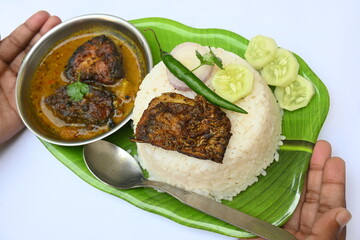 Delicious Indian fish curry with rice. Traditional Asian fish curry dish. Asian food and meal. It is liked all over India. Indian style fish curry served in plate with rice. Indian food. 