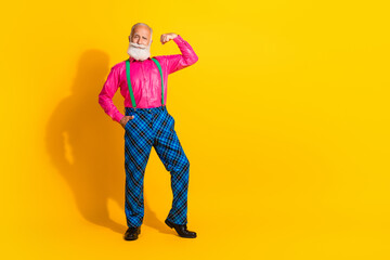 Full body photo of retired man flexing muscles dressed pink shirt vintage plaid pants fancy clothes...