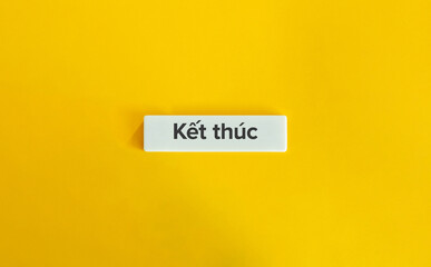 The End Word. Text on Block Letter Tile on Yellow Background. Minimal Aesthetic.