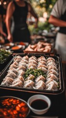 Naklejka premium Dumplings are arranged on a tray with green onion, while family prepares more dishes