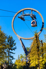 a cable car with round passenger cabins, vertical photo. cable car against blue sky. aerial...