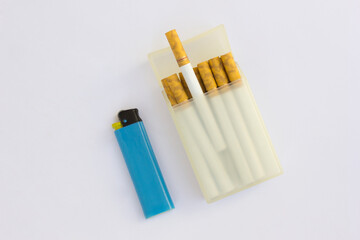 A pack of cigarettes and a blue lighter. Cigarette smoking is a significant public health concern due to its extensive and detrimental effects on various bodily systems and overall health.