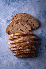Gordijnen Sliced bread on blue backgrouns © Yulia Furman
