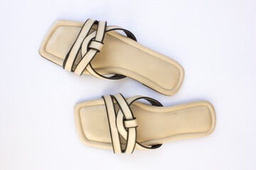 A pair of beautiful women's strap open-toed slippers. These slippers are made of synthetic leather.