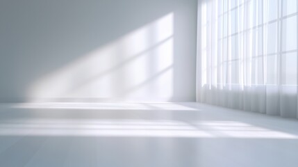 A large, empty room with a window and white curtains