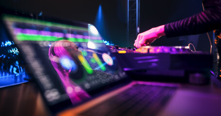 Laptop Computer with Working DJ Music Software Standing on a Table on Stage at a Concert. Beautiful...
