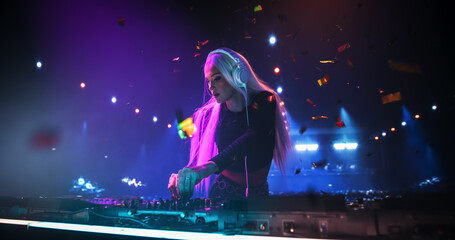 Female Pop Musician in Black Outfit Performing Techno and House Music on a Club Stage, Passionately...