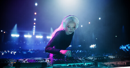 Female Pop Musician in Black Outfit Performing Techno and House Music on a Club Stage, Passionately...