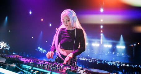 Beautiful Female DJ Playing Dance Music Sets, EDM, Techno, House Tracks at a Nightclub with...