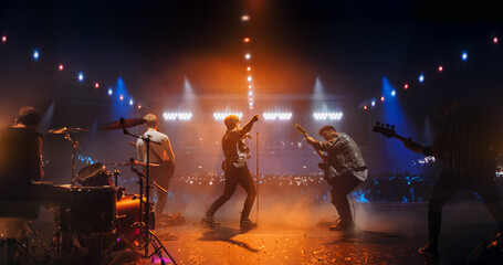 Stylish Lead Singer Performing at a Rock Concert Live on Stage. Talented Musicians Bringing Their...