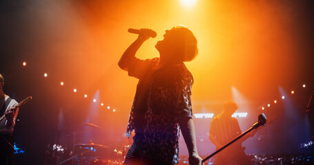 Energetic Rock Band Performing on a Nightclub Stage with Dynamic Lights and Special Effects....