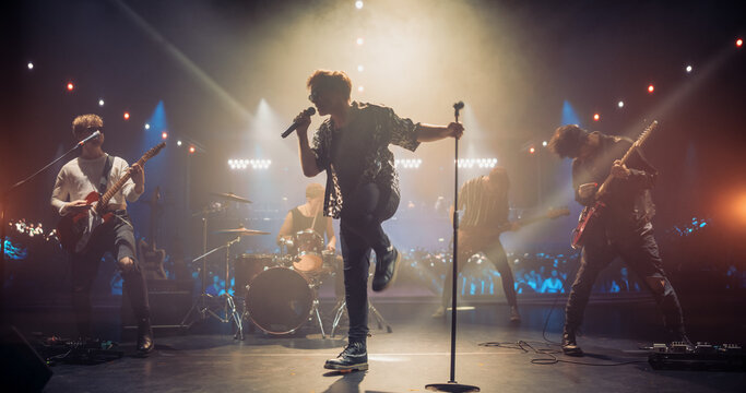 Rock Band Delivers a Captivating Concert with Lead Singer Passionately Performing on Stage with Falling Confetti, Surrounded by Band Members, Creating an Intense and Immersive Musical Atmosphere