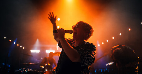 Portrait of a Lead Singer Performing at a Rock Concert Live on Stage with Confetti. Talented...