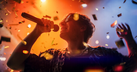 Portrait of a Lead Singer Performing at a Rock Concert Live on Stage with Confetti. Talented...