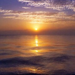 A high-resolution ultrarealistic image of a serene sunset over a calm ocean. This photograph captures a vivid, gradient sky transitioning from warm orange near the horizon to deeper purples at the top
