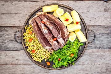 Traditional rustic tropical Brazilian dish, sun-dried beef with green beans, cassava, biquinho pepper. Creative rustic photography
