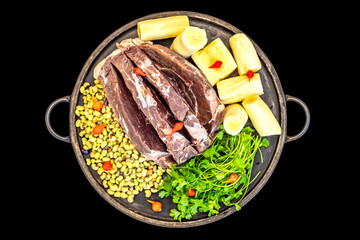 Traditional rustic tropical Brazilian dish, sun-dried beef with green beans, cassava, biquinho pepper. Creative rustic photography