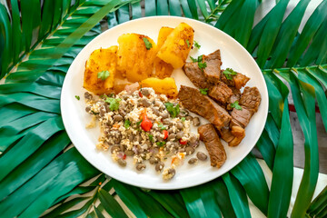 Traditional rustic tropical Brazilian dish, sun-dried beef with green beans, cassava, biquinho pepper. Creative rustic photography