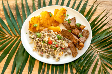 Traditional rustic tropical Brazilian dish, sun-dried beef with green beans, cassava, biquinho pepper. Creative rustic photography