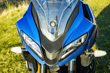 Front view of a motorcycle with mountains in the background.