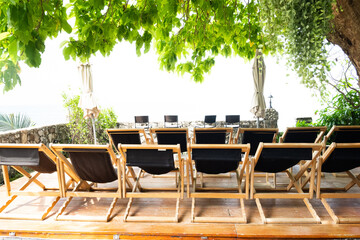 Sun loungers near city beach on a sunny day, Sunbeds or beach chairs at luxury hotel,holiday vacation.