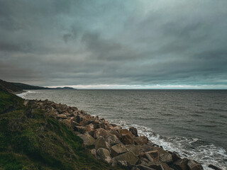 Sea defense rocks and a moody gothic sky. Riprap or rock armour an effective solution to protect...