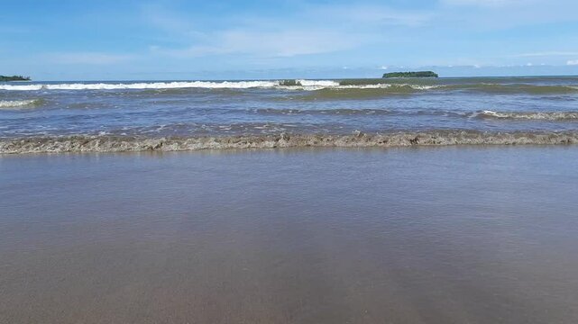 Peaceful Morning at Pariaman Beach with Calm Waves and Clear Water