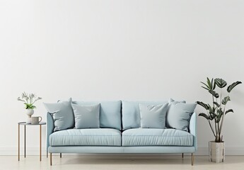A minimalist living room with a blue sofa, a potted plant, a side table, and a pendant light against a white wall
